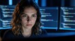 © miss irine - Woman developer types code late night on computer screens. Focused female coder works on programming project in dark office. She analyzes data on multiple monitors, concentrating on her task.