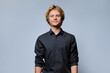 © Valerii Honcharuk - Frontal portrait of smiling young man looking at camera against grey background