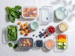 © NextGen Studio - Healthy food in glass meal prep containers with fresh vegetables and berries on a kitchen table. leakproof food containers