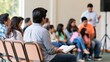© AZ Studio - Diverse group of people attending a community meeting in a bright indoor shared space setting