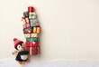 © Kassiopeia  - A penguin toy stands beside a stack of colorful Christmas gifts. The scene is on a light background with room for text. It captures the festive spirit of Christmas time