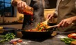 © Renaldi saleh - Two adults prepare spicy vegetables together as steam rises from a hot skillet in a cozy contemporary kitchen.