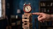 © abukanza - Red Retro Alarm Clock Balancing on Wooden Block Tower Being Touched