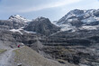 © Brian - Lone Hiker Resting on a Glacial Moraine Below Alpine Peaks