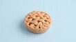 © Muhammad - Baked fruit pie featuring golden brown lattice crust on smooth light blue studio background surface