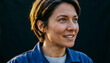 © unairakstudio - Close-up profile, a female engineer looking up with an expression of breakthrough and success, warm side light illuminating her face, clean dark background.