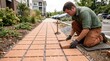 © Alexandr - Crew member installs permeable pavers for water drainage