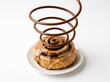 © Vikum - Chocolate cinnamon swirl pastry with caramel drizzle served on white plate for dessert presentation