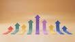 © Elias - Array of colorful arrows in different sizes pointing up on beige background.
