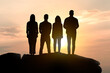 © New Africa - Silhouettes of employees against sunset sky. Teamwork concept