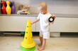 © Olga Murzaeva/Stocksy - The child with Down syndrome playing at home