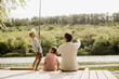 © BGStock72 - Joyful fishing moments by the serene lake with family on a sunny afternoon