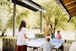 © BGStock72 - Family fun playing table tennis by the lakeside in bright afternoon sunlight