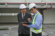 © ADD PHOTO - Engineer inspector hardhat safety vest clipboard factory industrial inspection during site walkthrough, adult men reviewing checklist and discussing compliance, risk management, and workplace