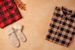 © Tayyaba - Autumn background with cozy flannel shirts and wool socks on corners, red and black plaid, warm beige center copy space
