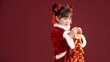 © BuiThi - Young Girl in Traditional Red Outfit Celebrating Chinese New Year