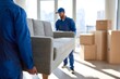 © maria_lh - Professional movers in blue uniforms lifting a sofa in a modern apartment. Furniture delivery and relocation service team working