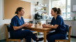 © Xenia - Two female nurses talking during break in hospital staff room. Healthcare workers conversing over coffee after medical shift