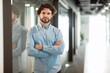 © Prostock-studio - Focused Man In Formal Attire, Crossed Arms, Standing In Office Environment, Displaying Confidence And Professionalism, Modern Setting, Business Concept.