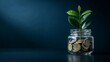 © borhan3251 - A small green plant growing out of a glass jar filled with golden coins against a dark blue background, symbolizing financial growth, investment, savings, and wealth accumulation for the future
