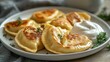 © Nataliya - fried vareniki with sour cream—Polish food