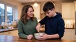 © Wonder Studio - A woman and a teenage boy are in a kitchen, both smiling as they prepare food together in a bowl.