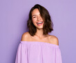 © Jack - A young lady with brown locks beams broadly in a lavender spaghetti-strap top. She exudes a joyful, upbeat demeanor against a simple purple studio backdrop.