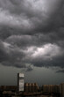 © ChaoShu Li/Stocksy - City view covered in dark clouds