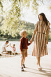 © BGStock72 - Joyful moments by the water with family during a sunny afternoon
