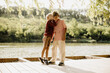 © BGStock72 - Joyful siblings sharing a warm moment near a tranquil lakeside setting