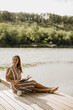 © BGStock72 - Enjoying a peaceful moment by the serene waters with a good book