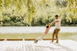 © BGStock72 - Father and child share joyful moments by the serene lakeside
