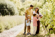 © BGStock72 - Family enjoys grape picking in a lush vineyard during a sunny afternoon