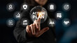© InfiniteFlow - A focused businesswoman interacts with a digital touchscreen displaying an action plan and various business icons, symbolizing strategy and teamwork in a modern workspace. Ledger