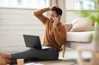 © Prostock-studio - Worried Black Man In His 30s Sitting On Floor, Taking Phone Call While Using Laptop At Home Office, Appearing Stressed And Concerned About Work. Focused On Troubleshooting Business Issues In