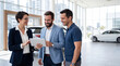 © Studio Fiuza - Car dealership sales team showing tablet to customer