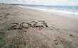 © velikiyzayats - Year 2027 written in sand on a tropical beach representing future time and new year resolutions