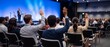 © Robert Garcia - Diverse group of people raising hands during a conference Q&A session in a modern auditorium