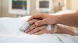 © Five Million Stock - Close up of loved one holding sick patient hand with fingertip pulse oximeter sensor clip in hospital bed. Family member providing compassionate emotional care. Generous copy space for design.