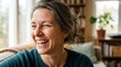 © morrisAi - Happy mature woman laughing indoors in cozy living room.