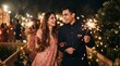 © RA - Couple holding burning sparklers in hand and celebrating diwali festival