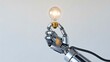 © Sajjad - Robot hand holding glowing light bulb representing artificial intelligence innovation and creative ideas
