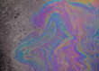 © Vectrology - Iridescent oil slick on wet asphalt, colorful gasoline spill texture, rainbow fuel puddle