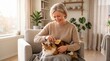© cloud7days - Mature Scandinavian Woman Brushing Pet With Slicker Brush