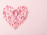 Pink breast cancer awareness ribbons arranged in heart shape with copy space