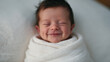 © BlackBridge Media - Adorable Newborn Baby Smiling While Sleeping Swaddled in Blanket