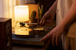 © Mediaphotos - Young adult Caucasian man placing stylus needle on vinyl record turntable at home. Closeup suitable for music streaming campaigns and lifestyle marketing