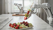 © Worker - Robotic arm holding a fruit skewer with strawberries, kiwi, and melon over a plate of fresh fruit