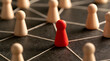 © Jack - The central figure made of red wood, which forms part of a linked system, symbolizes leadership and the organization's social structure.