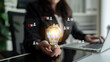 © InfiniteFlow - A businesswoman holds a glowing light bulb, symbolizing innovation amidst a digital network graphic. This image captures the essence of collaboration and creativity in a modern office setting. Cyphers